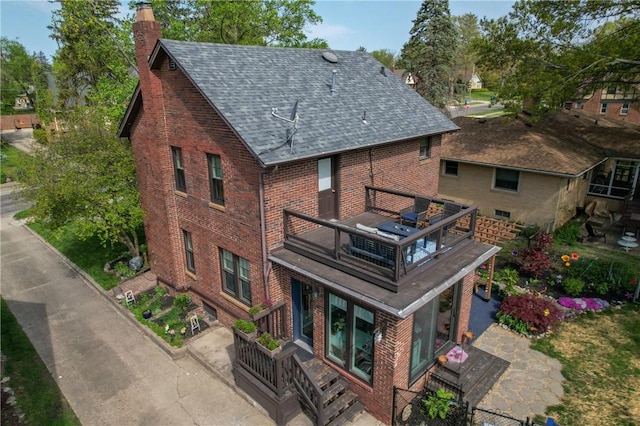 1805 N Gilbert St, Danville, IL 61832 - exterior space with brick siding, a chimney, a balcony, and roof with shingles