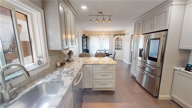 1805 N Gilbert St, Danville, IL 61832 - kitchen featuring a sink, tile patterned floors, a wealth of natural light, and stainless steel appliances