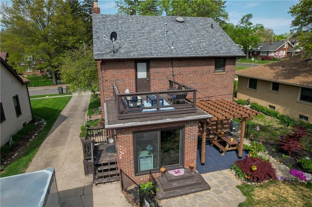 1805 N Gilbert St, Danville, IL 61832 - rear view of house with roof with shingles, a chimney, a balcony, and brick siding