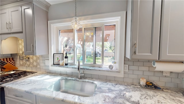 1805 N Gilbert St, Danville, IL 61832 - kitchen featuring plenty of natural light, decorative backsplash, pendant lighting, and a sink