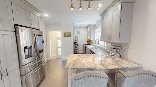 1805 N Gilbert St, Danville, IL 61832 - kitchen with light tile patterned floors, appliances with stainless steel finishes, plenty of natural light, and backsplash