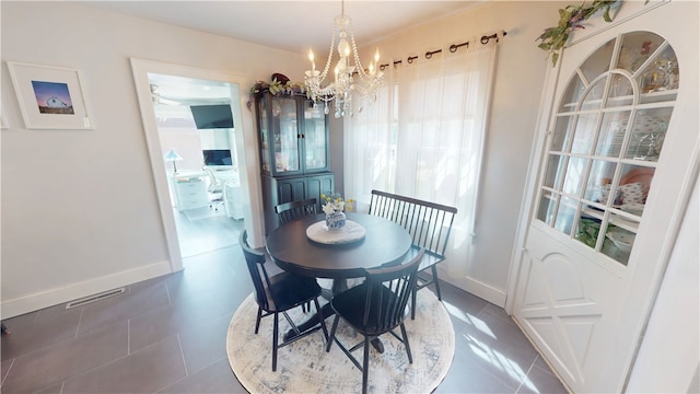 1805 N Gilbert St, Danville, IL 61832 - tiled dining area with baseboards, a notable chandelier, and visible vents