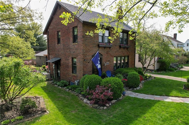 1805 N Gilbert St, Danville, IL 61832 - view of front of house with roof with shingles, a front yard, and brick siding