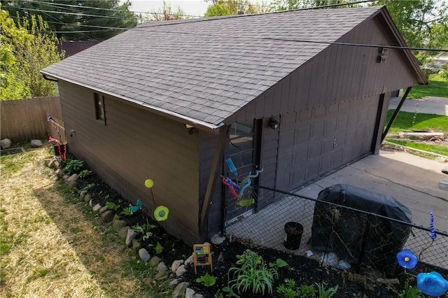 1805 N Gilbert St, Danville, IL 61832 - view of side of property featuring a garage, roof with shingles, and fence