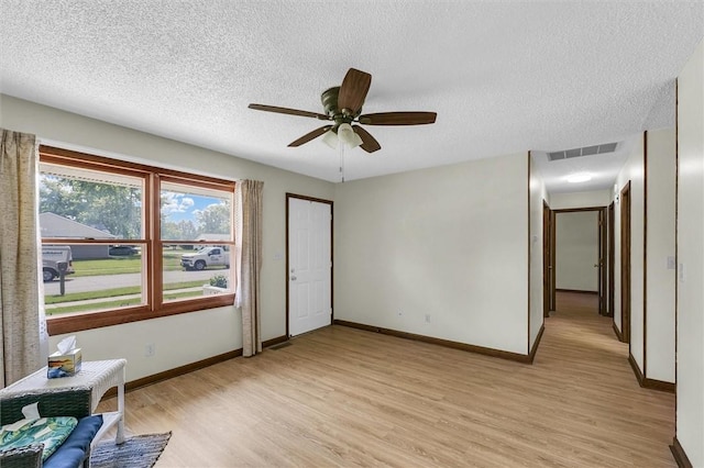946 Foxcrest Dr, Charleston, IL 61920 - unfurnished room featuring light wood finished floors, a textured ceiling, and ceiling fan