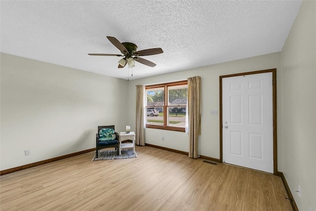 946 Foxcrest Dr, Charleston, IL 61920 - sitting room featuring light wood-style flooring, a ceiling fan, and a textured ceiling
