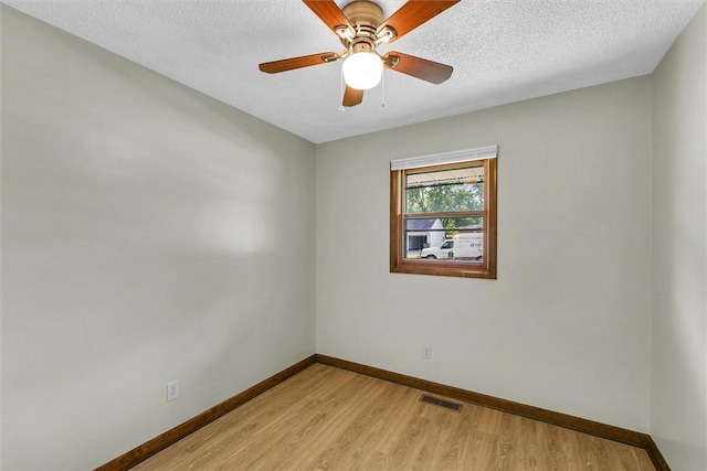 946 Foxcrest Dr, Charleston, IL 61920 - unfurnished room with light wood finished floors, ceiling fan, and a textured ceiling
