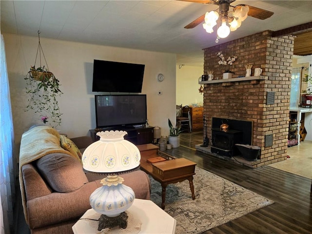 14317 N 920 E Rd, Fairmount, IL 61841 - living area with ceiling fan, a wood stove, and wood finished floors