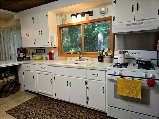14317 N 920 E Rd, Fairmount, IL 61841 - kitchen with white gas range oven, under cabinet range hood, white cabinets, and light countertops