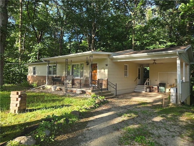 14317 N 920 E Rd, Fairmount, IL 61841 - ranch-style home with covered porch, an attached carport, and dirt driveway