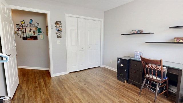 office space featuring baseboards and wood finished floors