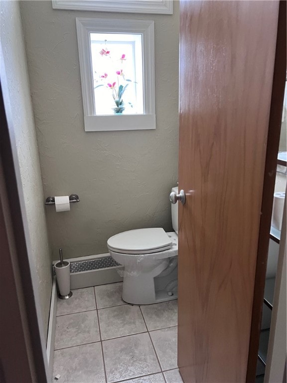 bathroom featuring tile patterned flooring and toilet