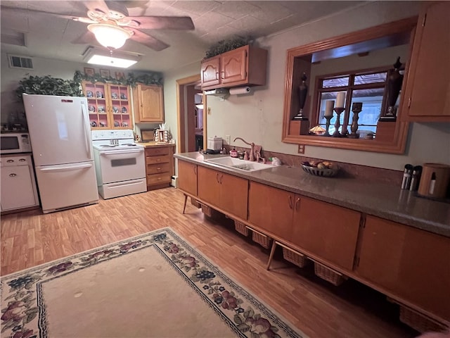 kitchen with ceiling fan, sink, white appliances, and light hardwood / wood-style flooring