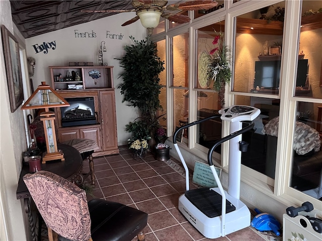 interior space with ceiling fan and vaulted ceiling