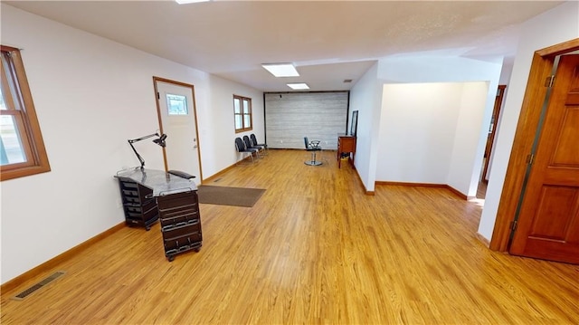 exercise room featuring light wood-type flooring