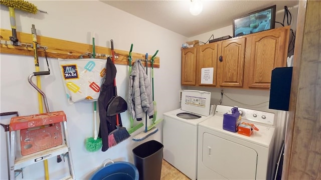 laundry room featuring cabinets and separate washer and dryer