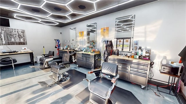 miscellaneous room with concrete floors and coffered ceiling