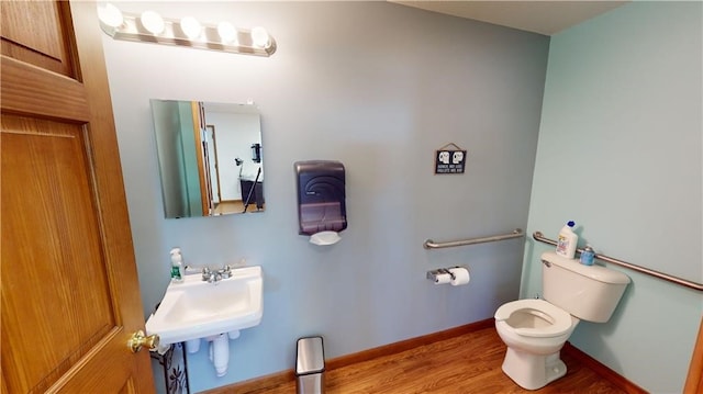 bathroom with sink, toilet, and hardwood / wood-style flooring