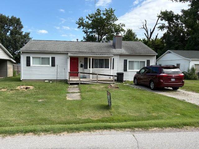 700 E Gordon Ave, Effingham, IL 62401 - ranch-style house featuring a chimney, a front yard, covered porch, and a garage