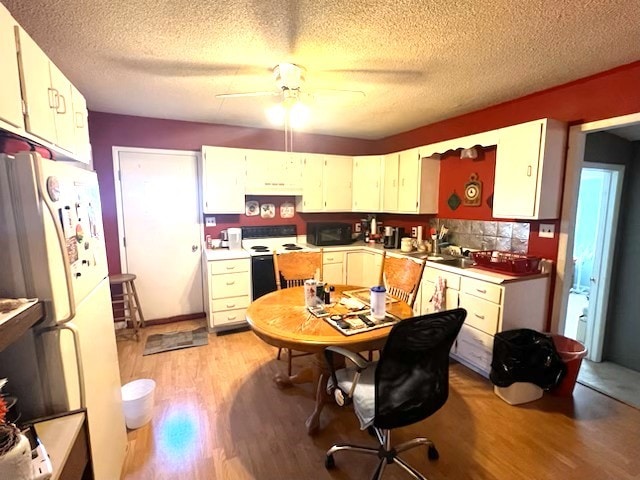 700 E Gordon Ave, Effingham, IL 62401 - kitchen featuring light wood-style flooring, freestanding refrigerator, ceiling fan, electric range oven, and black microwave