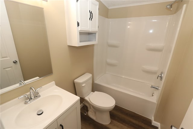 full bathroom featuring crown molding, hardwood / wood-style floors, shower / bath combination, toilet, and vanity