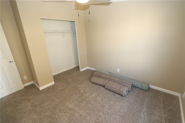 unfurnished bedroom with carpet floors, a closet, and ceiling fan