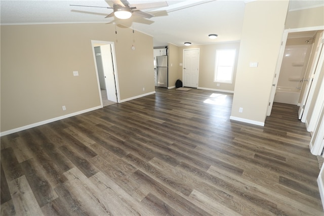 unfurnished living room featuring vaulted ceiling, crown molding, ceiling fan, and dark hardwood / wood-style floors