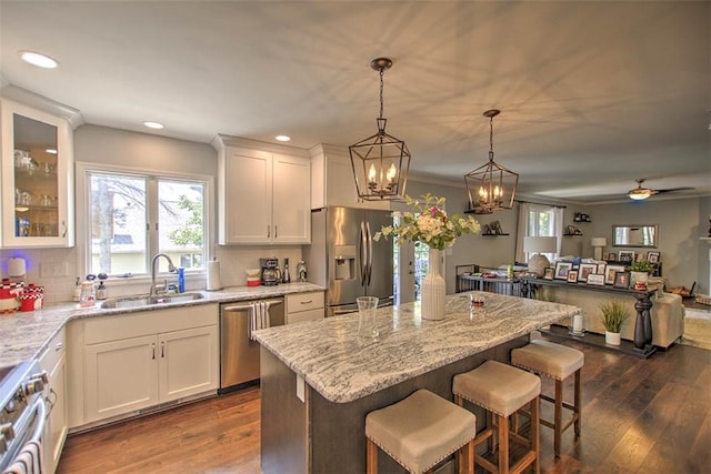1077 Cornell Dr, Decatur, IL 62522 - kitchen featuring appliances with stainless steel finishes, white cabinetry, dark wood-style floors, light stone countertops, and recessed lighting