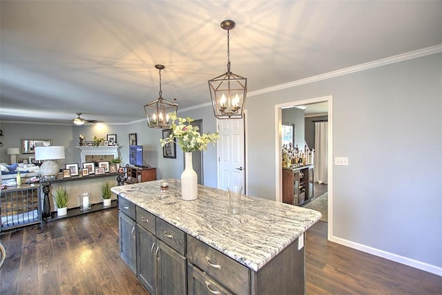 1077 Cornell Dr, Decatur, IL 62522 - kitchen featuring a fireplace, a chandelier, pendant lighting, dark wood-style flooring, and crown molding
