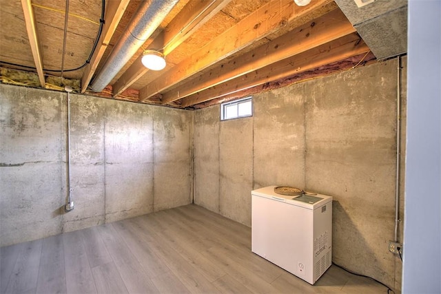 1077 Cornell Dr, Decatur, IL 62522 - basement with fridge and wood finished floors