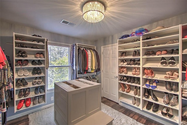 1077 Cornell Dr, Decatur, IL 62522 - spacious closet featuring a chandelier and dark wood-style floors