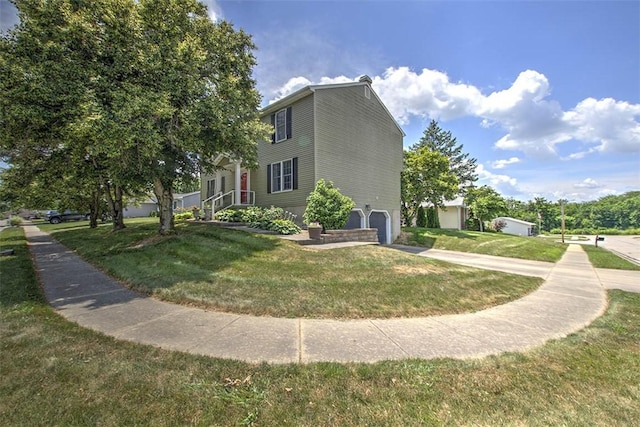 1077 Cornell Dr, Decatur, IL 62522 - view of home's exterior with an attached garage, a yard, and concrete driveway