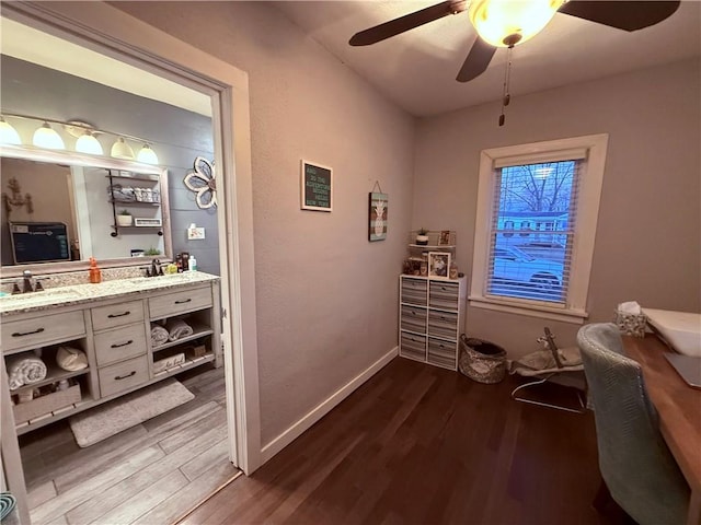 interior space with ceiling fan, dark hardwood / wood-style flooring, and sink