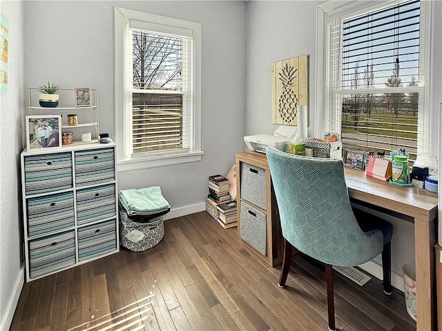 office space with dark wood-style flooring and baseboards