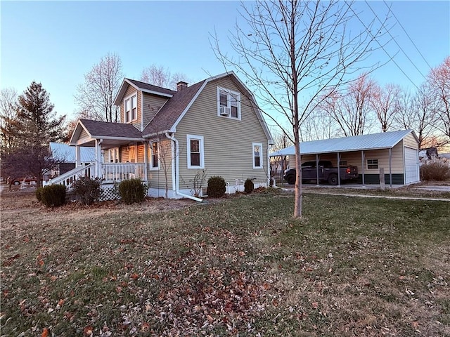 view of side of home with a carport, a porch, and a yard