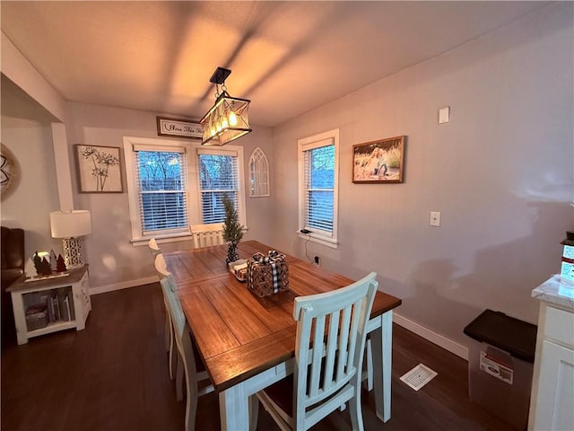 dining room featuring dark hardwood / wood-style floors and a healthy amount of sunlight