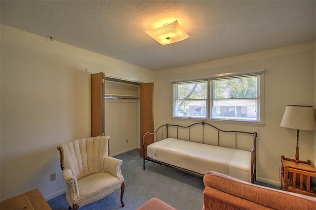 sitting room featuring carpet floors, a textured ceiling, and baseboards