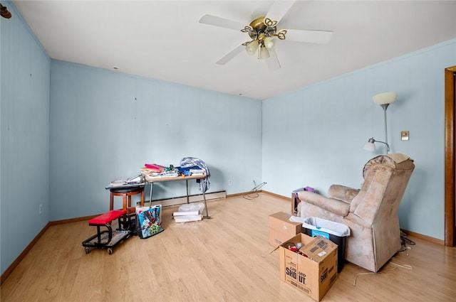 516 E Monroe Ave, Chrisman, IL 61924 - unfurnished room with wood finished floors, a baseboard radiator, a ceiling fan, and baseboards