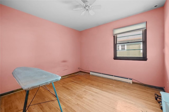 516 E Monroe Ave, Chrisman, IL 61924 - empty room featuring a baseboard heating unit, light wood-style flooring, baseboards, and ceiling fan