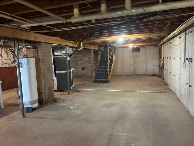 2496 N 300th St, Mason, IL 62443 - unfinished basement with gas water heater, heating unit, and stairs