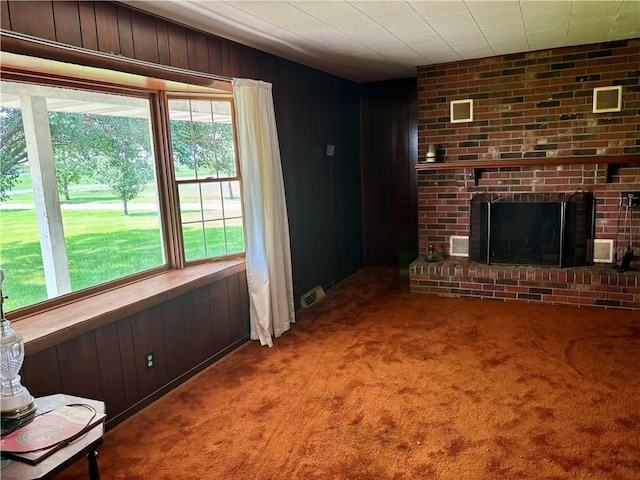 2496 N 300th St, Mason, IL 62443 - unfurnished living room with carpet flooring, wooden walls, and a brick fireplace