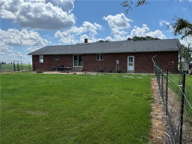 2496 N 300th St, Mason, IL 62443 - rear view of house featuring entry steps, brick siding, a fenced backyard, and a chimney