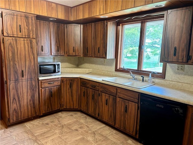 2496 N 300th St, Mason, IL 62443 - kitchen with black dishwasher, stainless steel microwave, light countertops, and brown cabinets