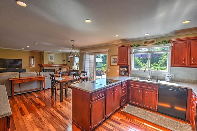 95 Hickory Point Ct, Forsyth, IL 62535 - kitchen featuring black appliances, ornamental molding, open floor plan, wood-type flooring, and a peninsula