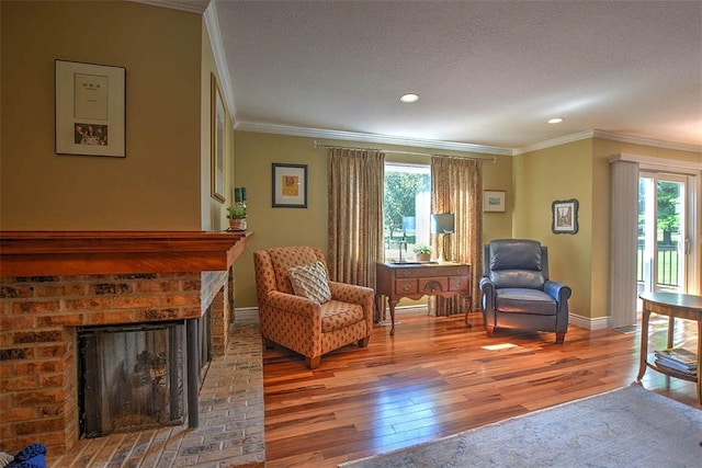 95 Hickory Point Ct, Forsyth, IL 62535 - living area featuring wood-type flooring, ornamental molding, a brick fireplace, and recessed lighting