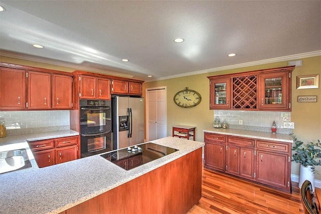 95 Hickory Point Ct, Forsyth, IL 62535 - kitchen featuring black appliances, ornamental molding, light wood-style flooring, recessed lighting, and tasteful backsplash