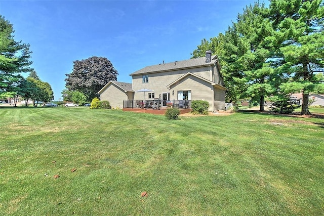 95 Hickory Point Ct, Forsyth, IL 62535 - back of property featuring a deck, a yard, and a chimney