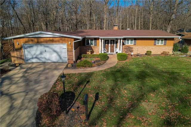 ranch-style house with a garage and a front lawn