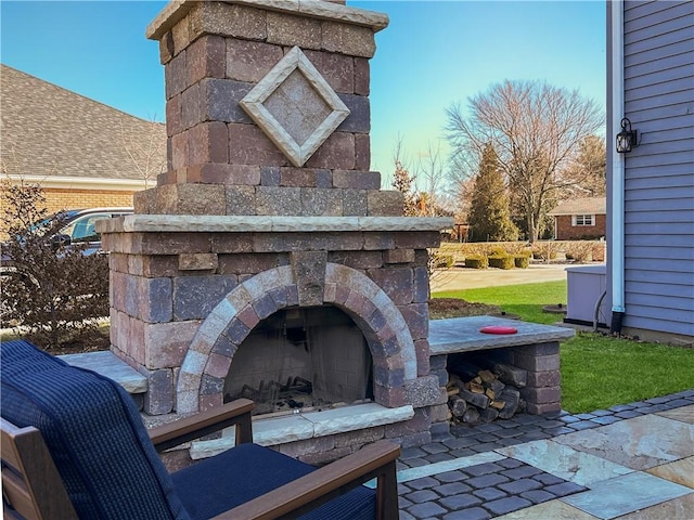 view of patio with an outdoor stone fireplace