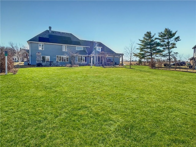 back of property featuring a lawn